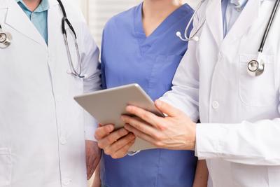 storyblocks-doctor-and-medical-team-discussing-patient-report-at-tablet-computer-in-hospital_Sjgn0_cYIN