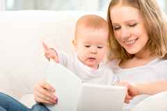 vecteezy_mother-reading-book-a-little-baby_1219338
