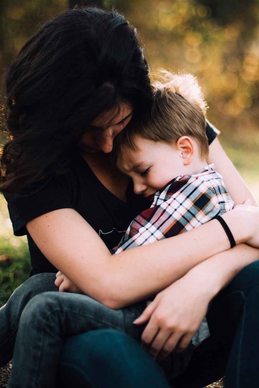 Canva - Mother Hugging Little Boy Outdoors