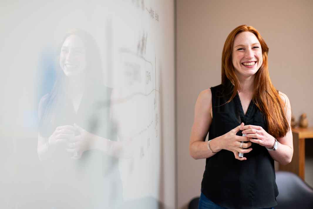 Smiling Teacher at Whiteboard