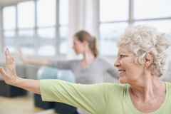Elderly-woman-doing-stretching-workout-at-yoga-class-000053160484_Large-1030x687