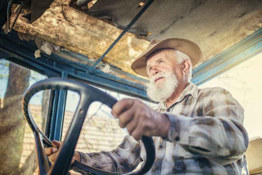 graphicstock-senior-man-at-the-farm-driving-an-old-tractor_r0Wnzwq6b-
