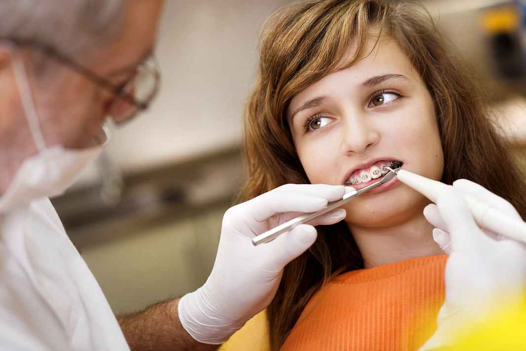 graphicstock-teenage-girl-with-the-braces-on-her-teeth-is-having-a-treatment-at-dentist_HCxB83tcbZ