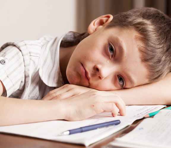 Crying Student Laying on Homework