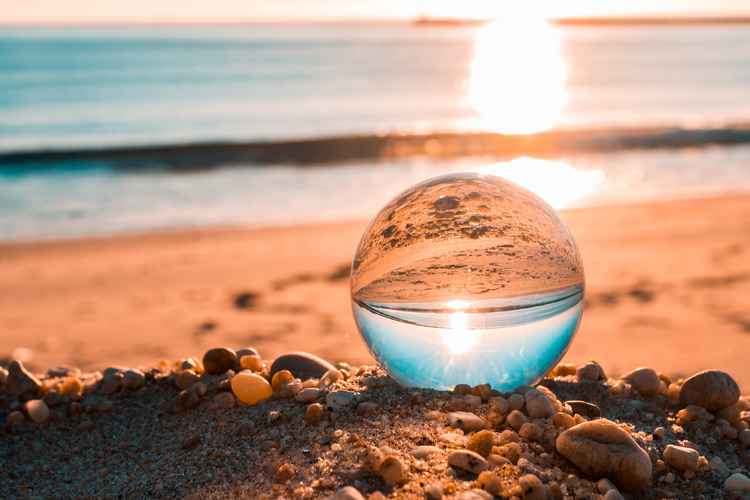 Canva - Clear Glass Ball on Brown Sands
