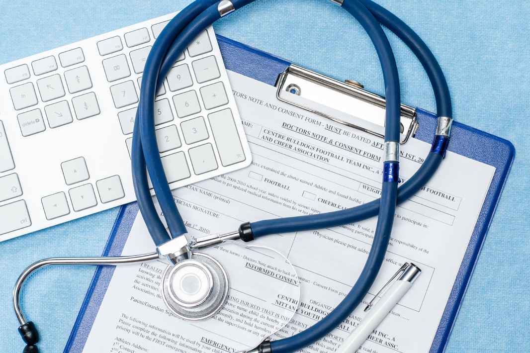 stethoscope-laying-over-doctors-emergency-report-medical-documentation