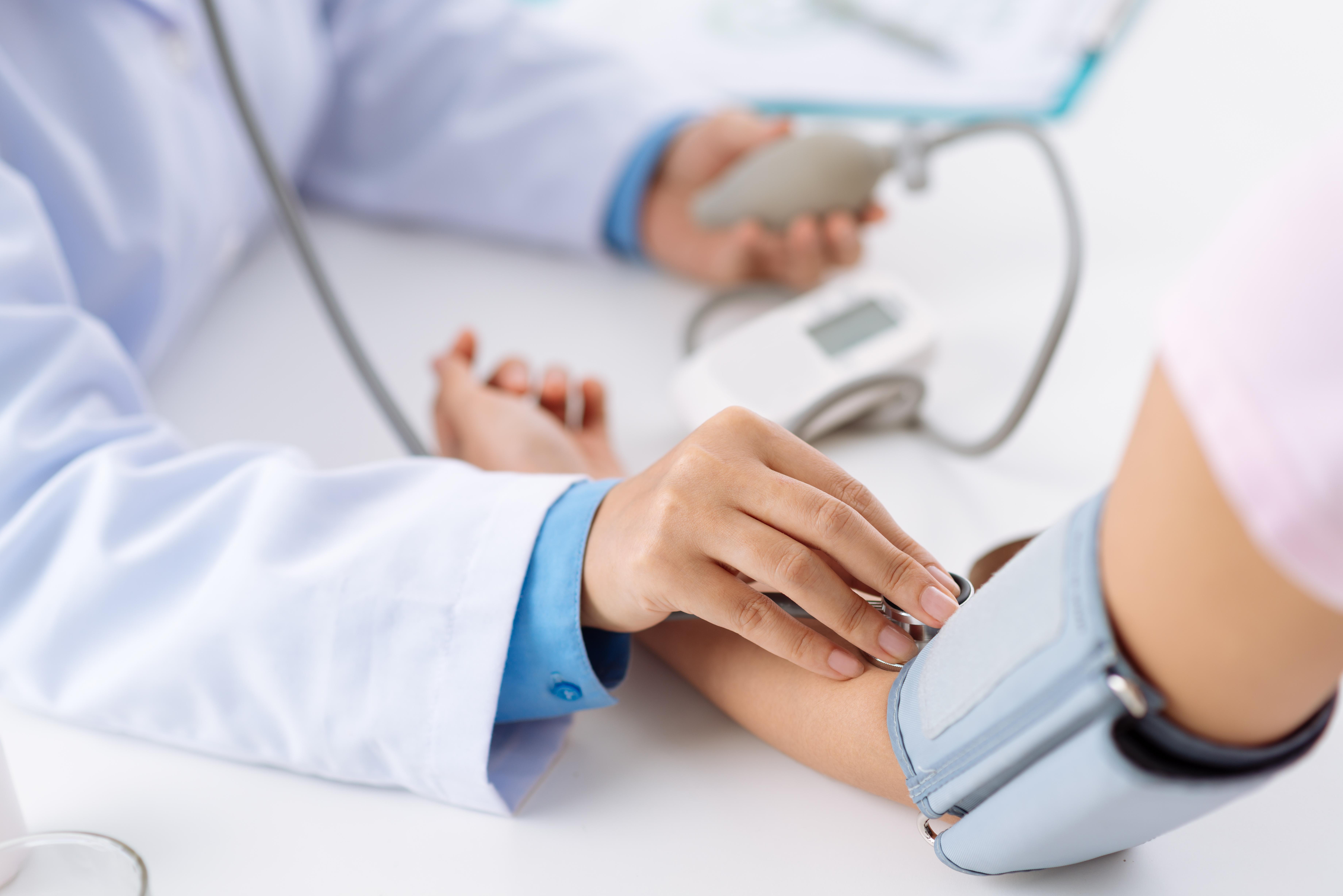 storyblocks-doctor-taking-pulse-of-the-patient-who-has-life-insurance-policy-view-from-the-top_rUTTENpbf