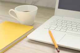 white laptop yellow pencil notebook coffee cup