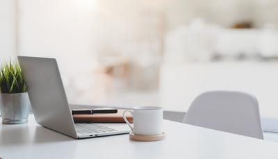 open laptop plant chair mug