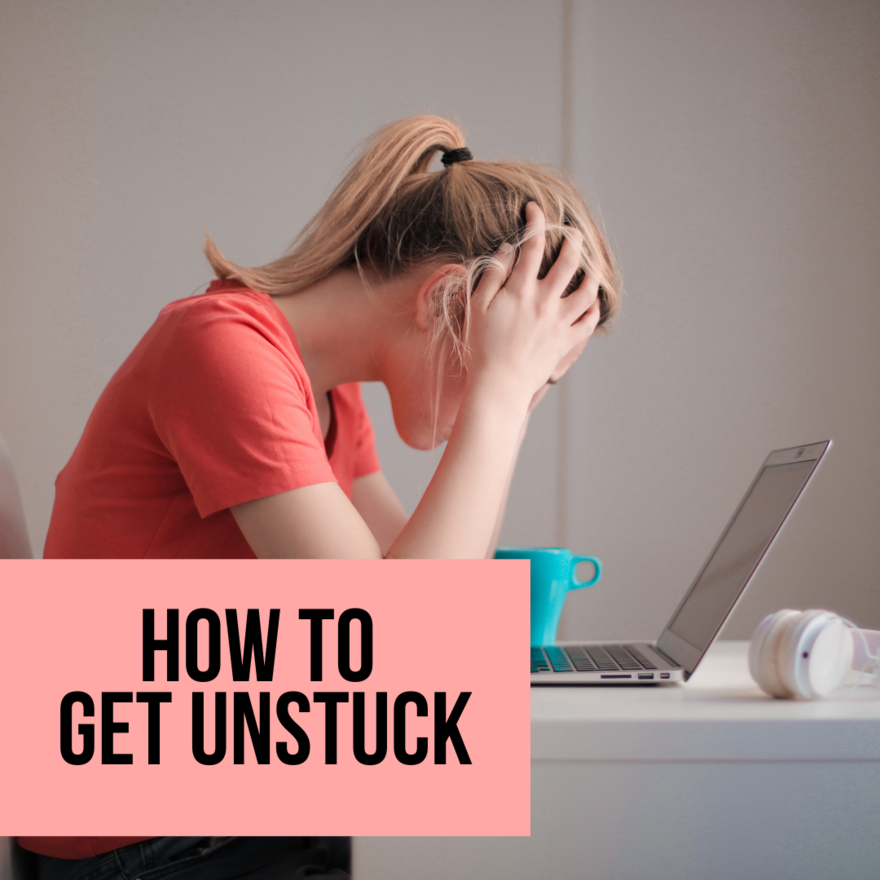 How To Get Unstuck Image of girl with head in her hands sitting in front of her laptop