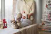 woman windowsill socks fairy lights