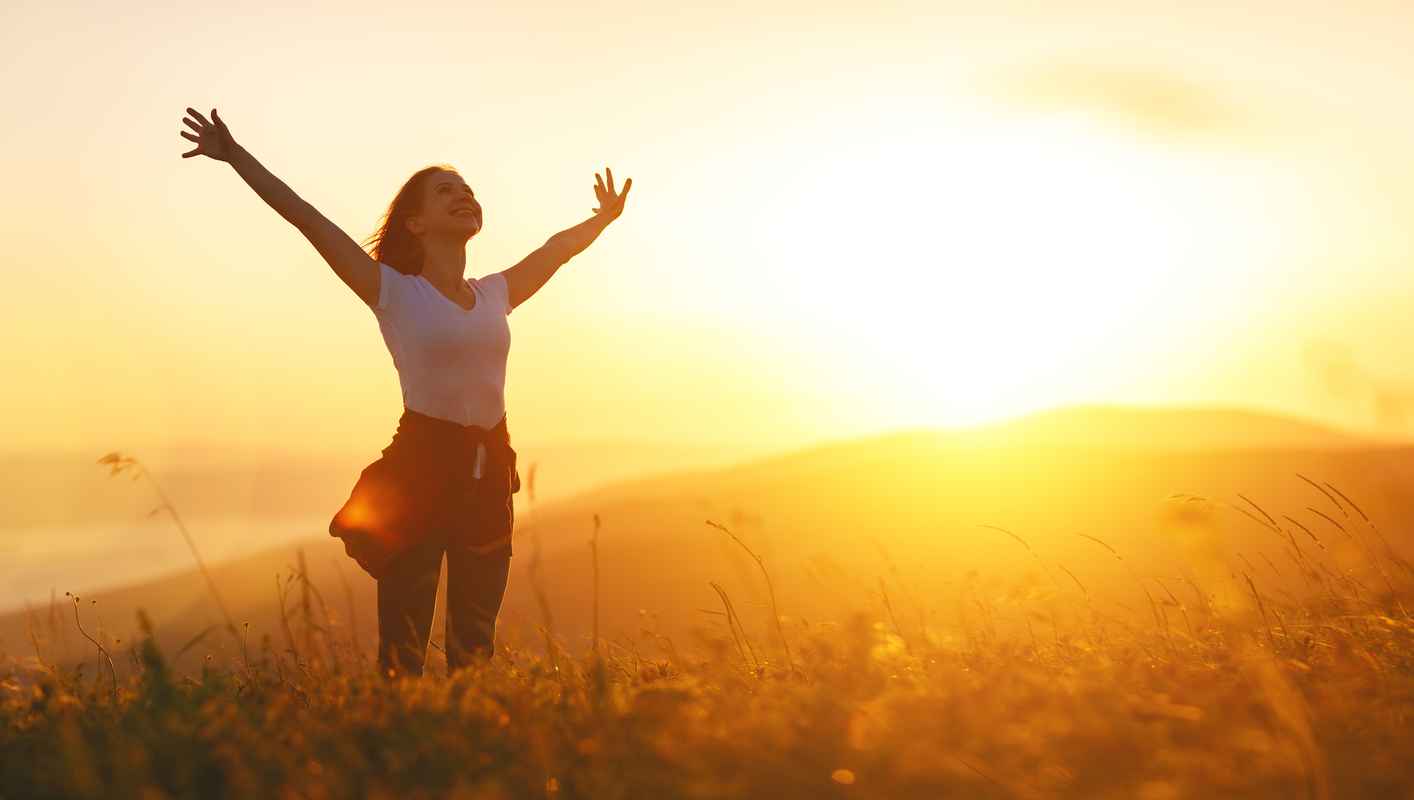 happy-woman-on-sunset-in-nature-iwith-open-hands-95038703