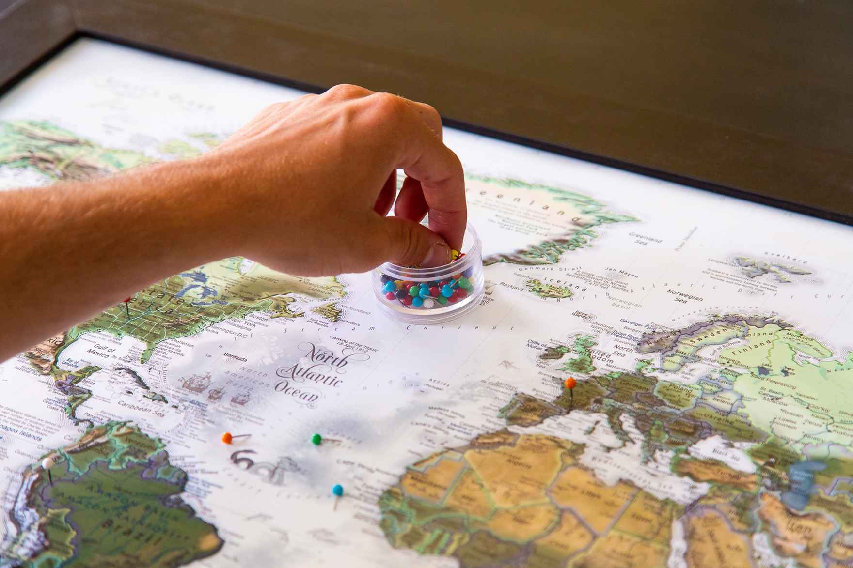 map-with-hand-and-pushpins