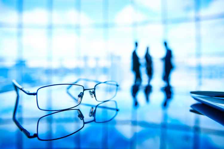 close-up-glasses-with-employees-background