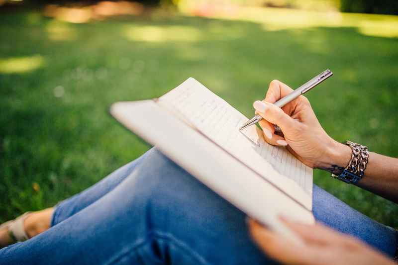 A-woman-writing-down-personal-quotes-about-recovery-in-a-journal