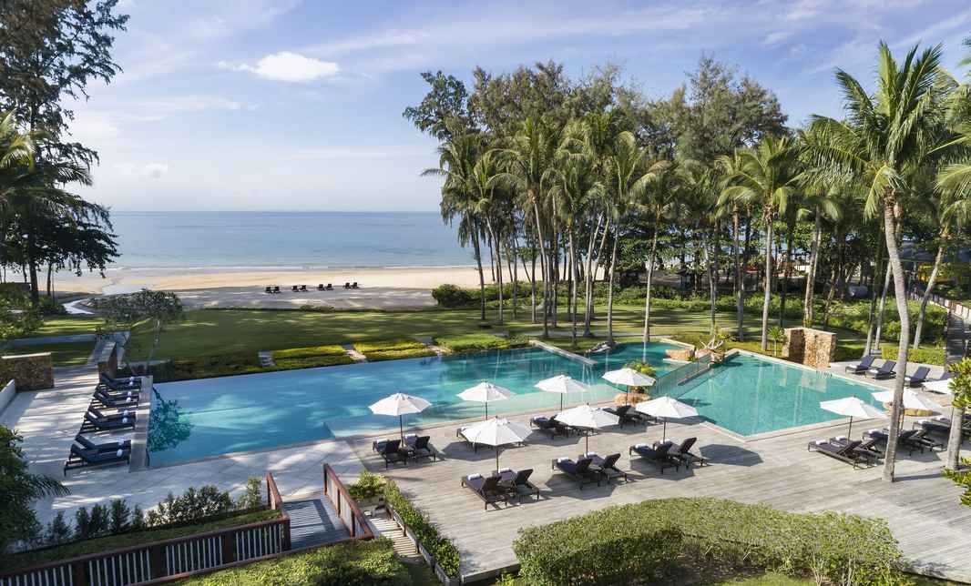dusit-thani-krabi-pool-beach-view-trees-sun-deck