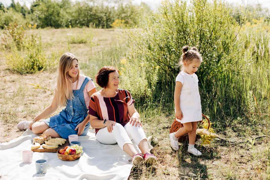 grandmother-her-two-granddaughters-have-picnic-nature-spend-time-together-weekends